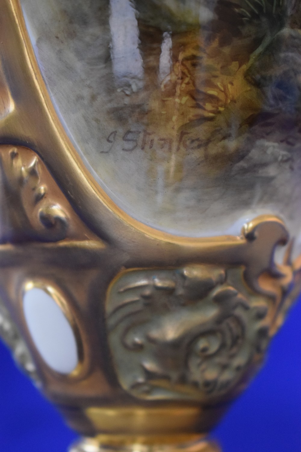 An antique Royal Worcester covered porcelain urn featuring hand-painted Highland cattle, twin gilded handles, and a pointed finial. View VI