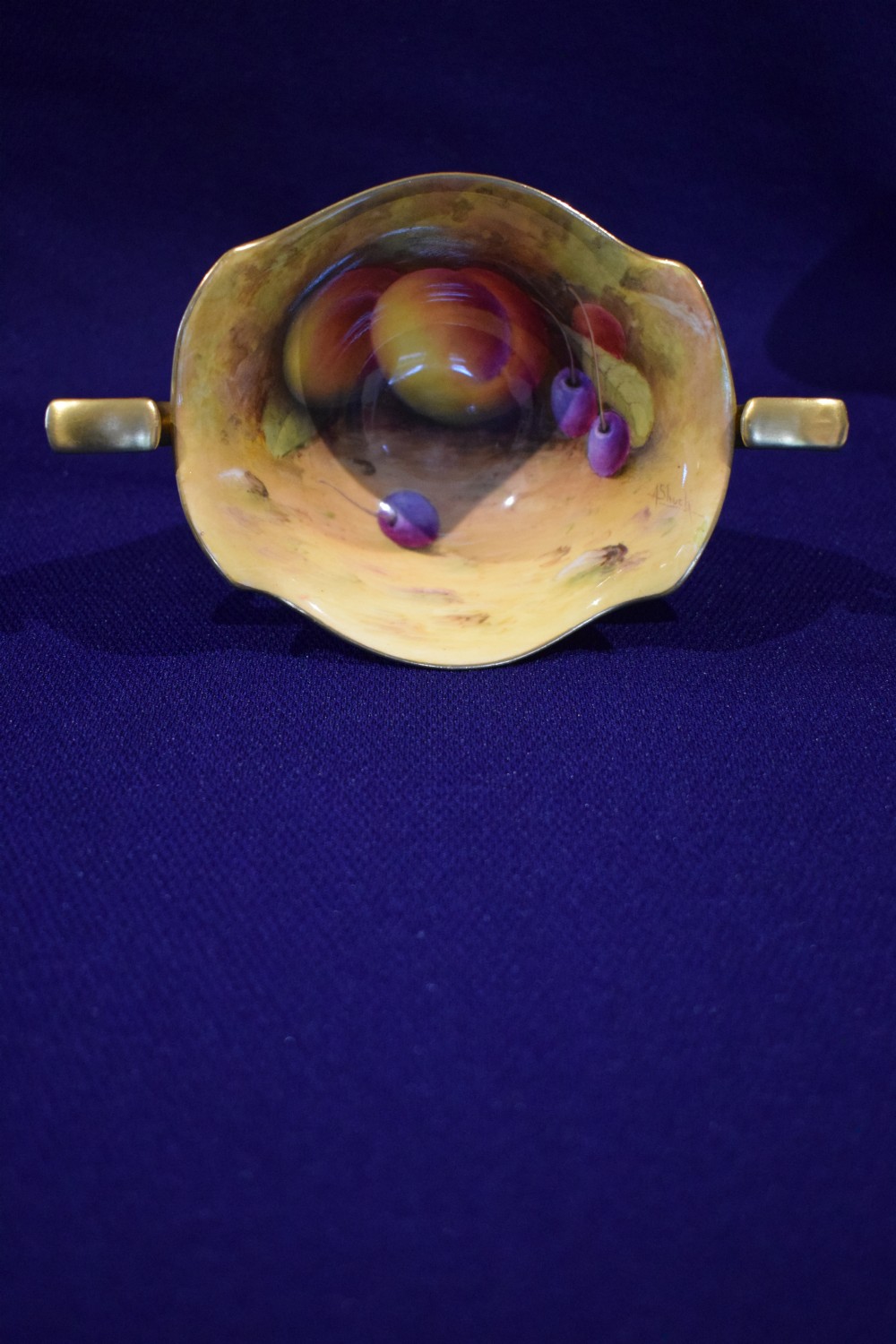 A small footed bone china sugar bowl with twin gilded handles, a gold exterior, and an interior featuring hand-painted peaches and cherries. View III