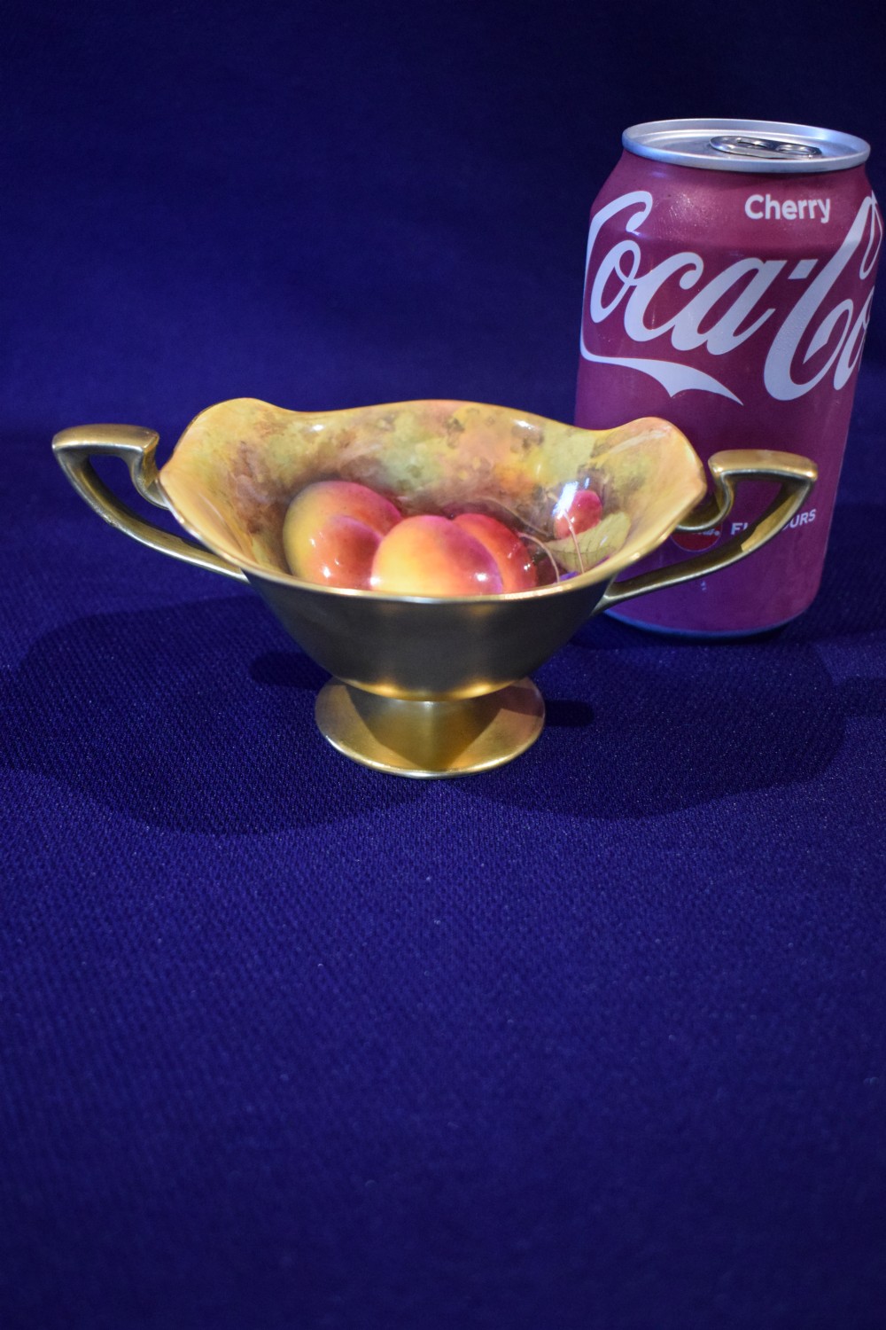 A small footed bone china sugar bowl with twin gilded handles, a gold exterior, and an interior featuring hand-painted peaches and cherries. View IV