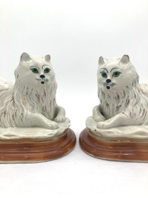 AN UNUSUAL PAIR OF LATE 19TH CENTURY RECUMBENT STAFFORDSHIRE CATS - ADDITIONAL PHOTO 1