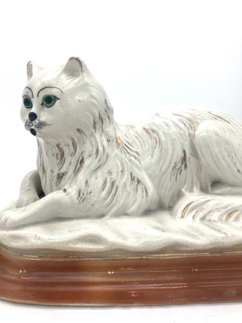 AN UNUSUAL PAIR OF LATE 19TH CENTURY RECUMBENT STAFFORDSHIRE CATS - ADDITIONAL PHOTO 2