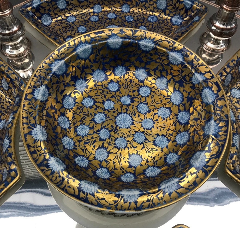 An early 19th-century Coalport porcelain supper set featuring cobalt blue and gold floral pattern covered dishes and condiment shakers set on a revolving silver-plated tray with dark wood handles. View VI