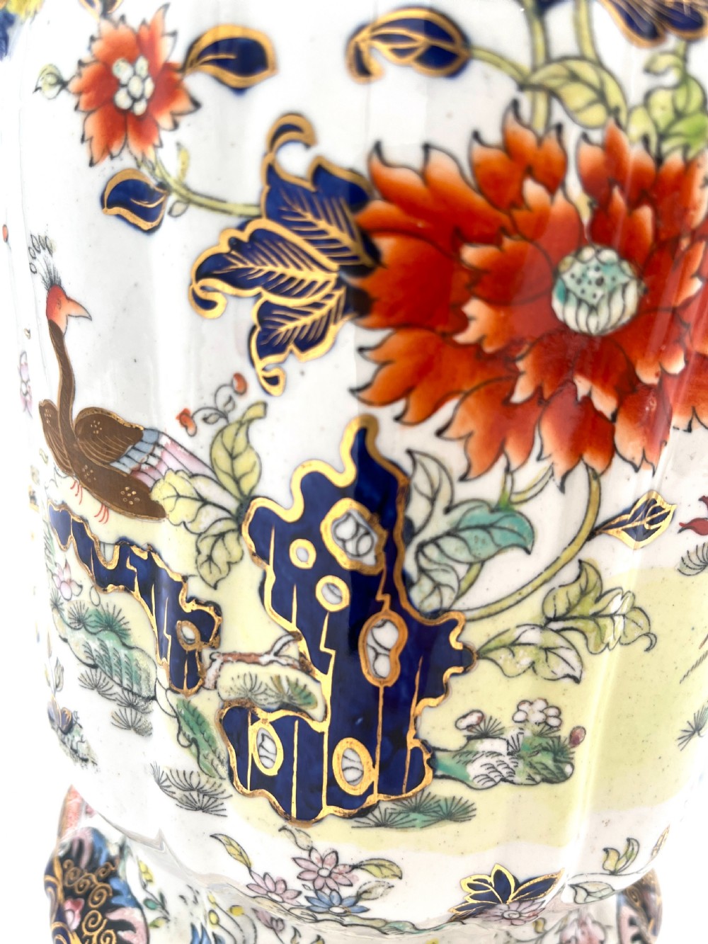 A pair of white and cobalt blue ceramic ironstone essence jars adorned with floral motifs, scroll handles, and fitted lids. View IV