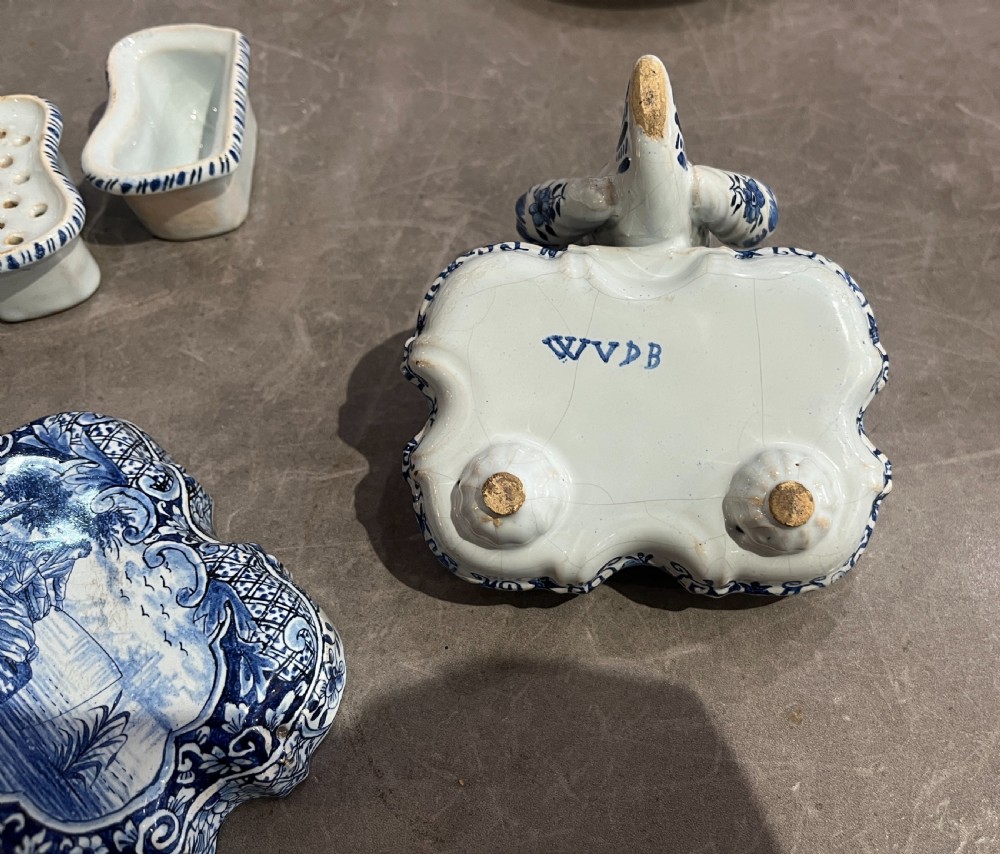 An antique blue and white tin-glazed earthenware inkstand featuring a central hand-painted pictorial scene and attached pen sockets. View III