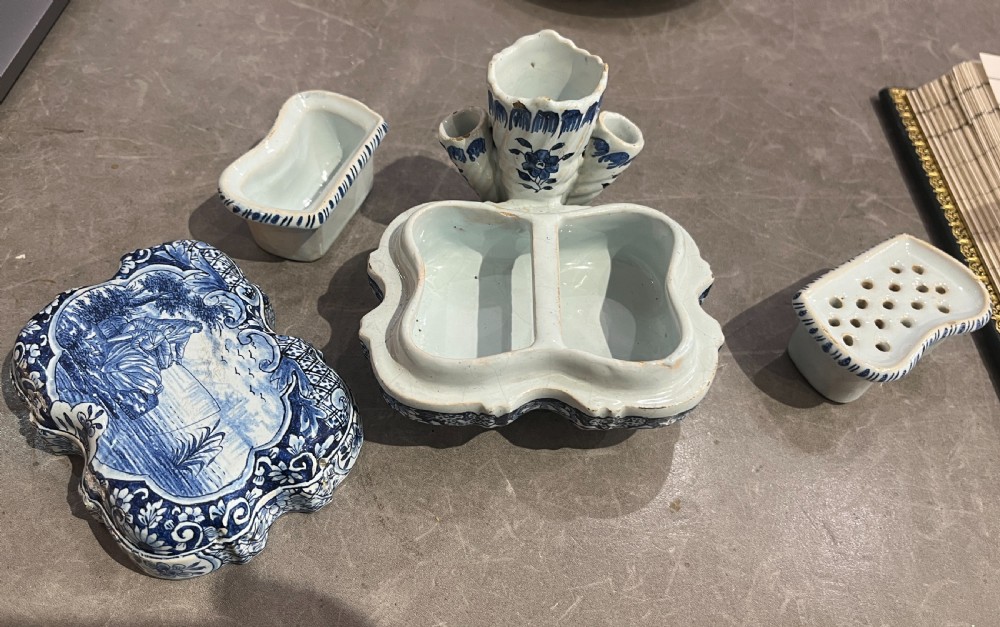 An antique blue and white tin-glazed earthenware inkstand featuring a central hand-painted pictorial scene and attached pen sockets. View II