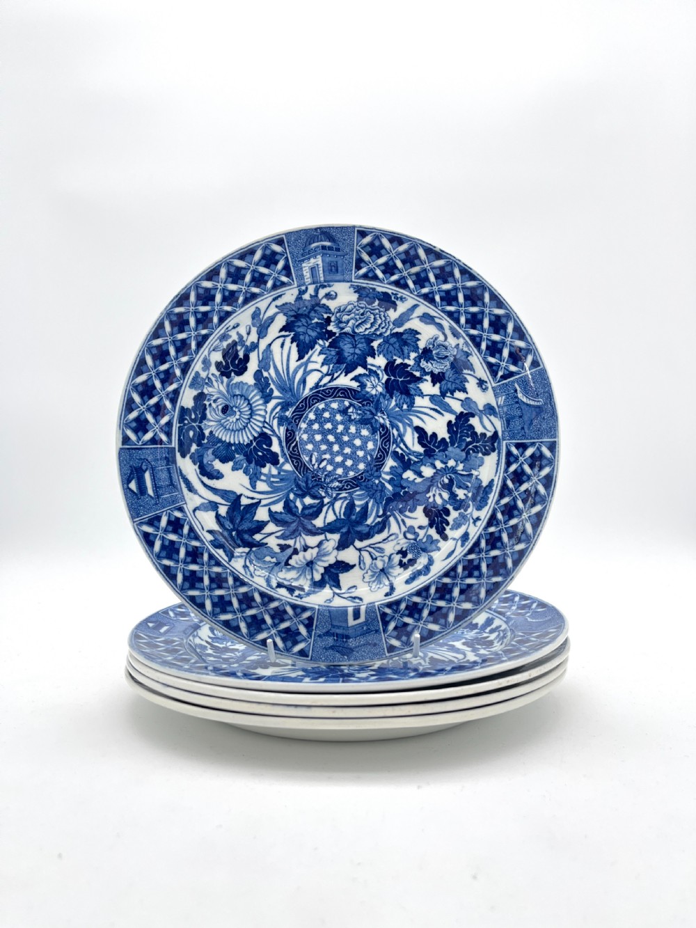 An extensive blue and white transfer-printed Wedgwood earthenware dinner service in the Hibiscus pattern featuring plates, serving dishes, and a covered tureen. View II
