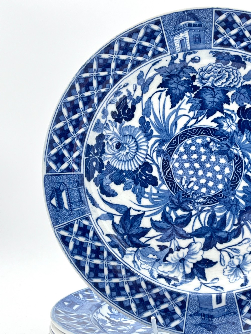 An extensive blue and white transfer-printed Wedgwood earthenware dinner service in the Hibiscus pattern featuring plates, serving dishes, and a covered tureen. View III