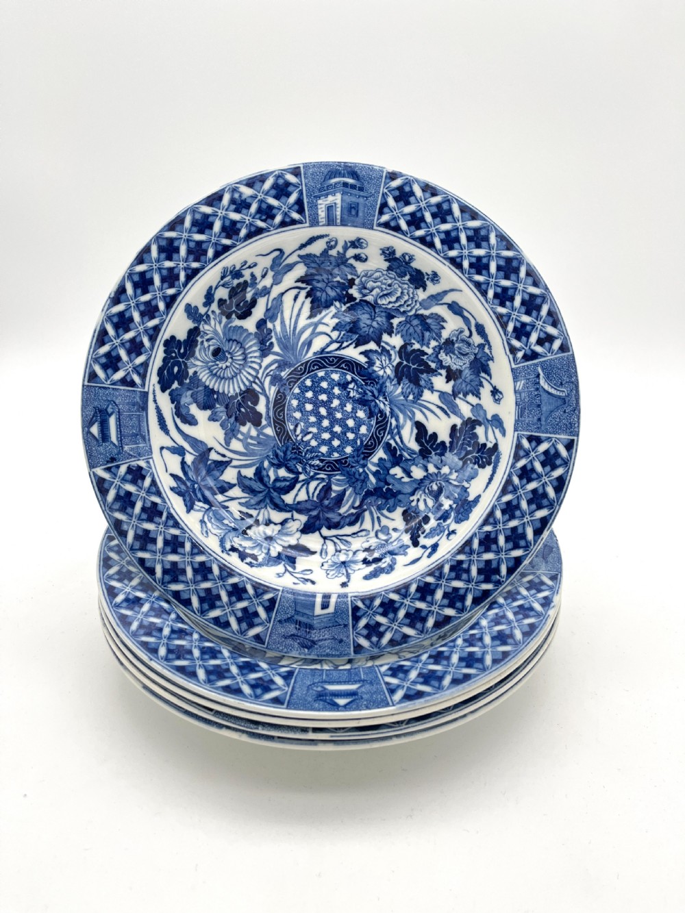 An extensive blue and white transfer-printed Wedgwood earthenware dinner service in the Hibiscus pattern featuring plates, serving dishes, and a covered tureen. View IV