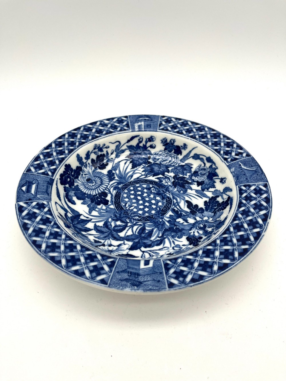 An extensive blue and white transfer-printed Wedgwood earthenware dinner service in the Hibiscus pattern featuring plates, serving dishes, and a covered tureen. View V