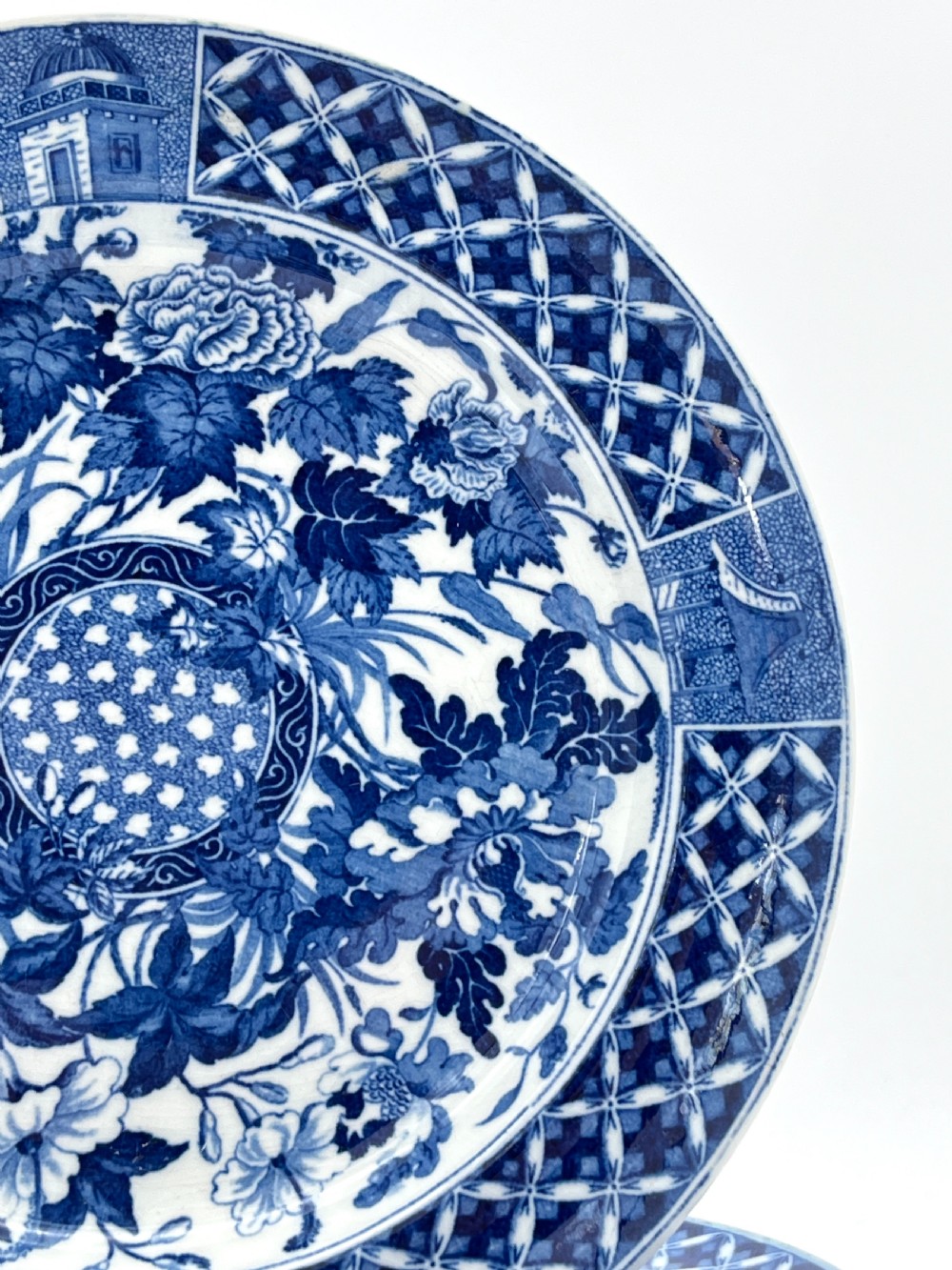 An extensive blue and white transfer-printed Wedgwood earthenware dinner service in the Hibiscus pattern featuring plates, serving dishes, and a covered tureen. View VI