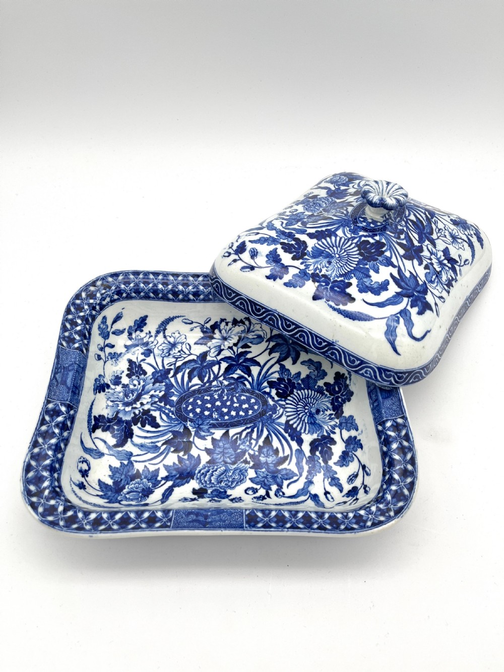 An extensive blue and white transfer-printed Wedgwood earthenware dinner service in the Hibiscus pattern featuring plates, serving dishes, and a covered tureen. View IX