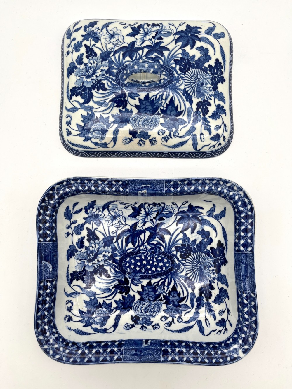 An extensive blue and white transfer-printed Wedgwood earthenware dinner service in the Hibiscus pattern featuring plates, serving dishes, and a covered tureen. View XII