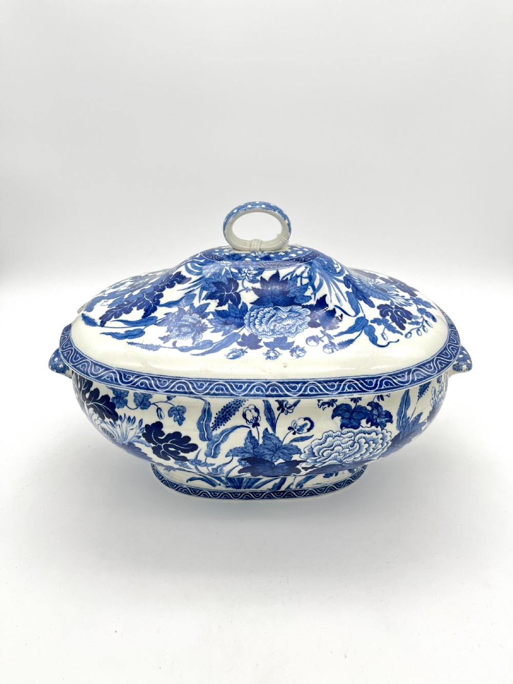 An extensive blue and white transfer-printed Wedgwood earthenware dinner service in the Hibiscus pattern featuring plates, serving dishes, and a covered tureen. View XIV