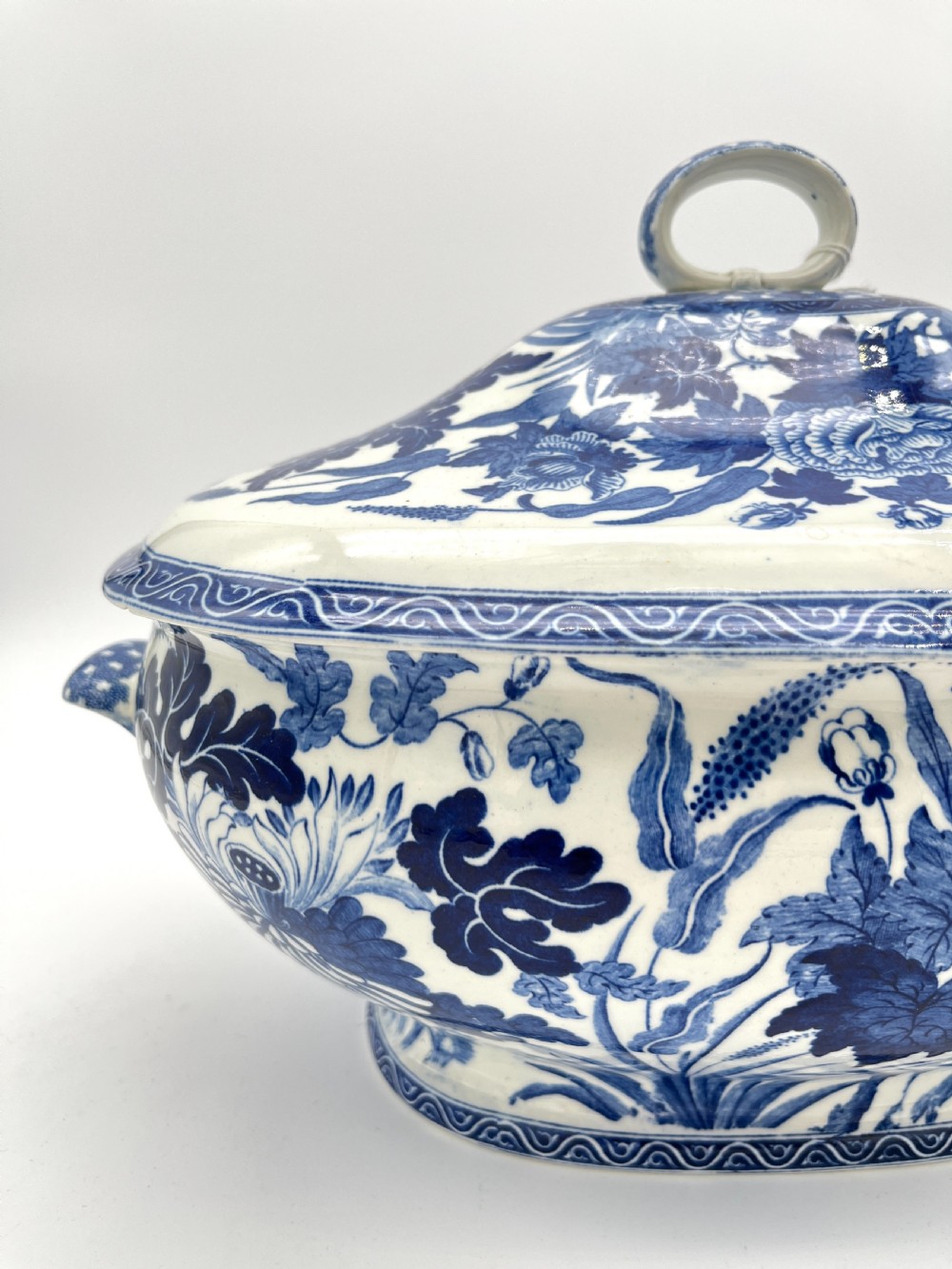 An extensive blue and white transfer-printed Wedgwood earthenware dinner service in the Hibiscus pattern featuring plates, serving dishes, and a covered tureen. View XV
