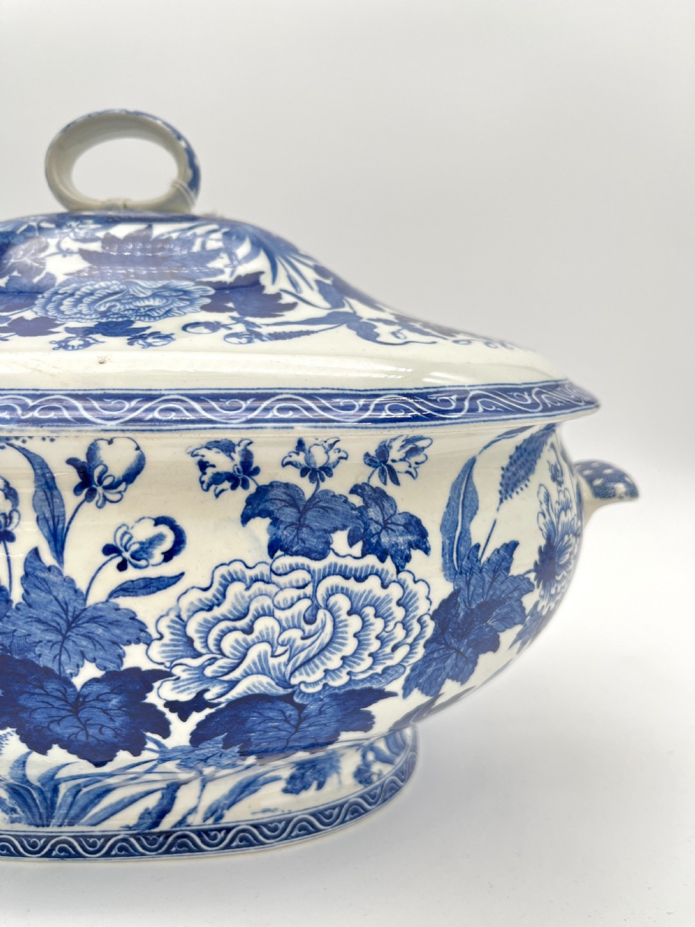 An extensive blue and white transfer-printed Wedgwood earthenware dinner service in the Hibiscus pattern featuring plates, serving dishes, and a covered tureen. View XVI