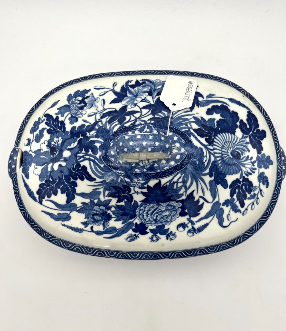 An extensive blue and white transfer-printed Wedgwood earthenware dinner service in the Hibiscus pattern featuring plates, serving dishes, and a covered tureen. View XVII