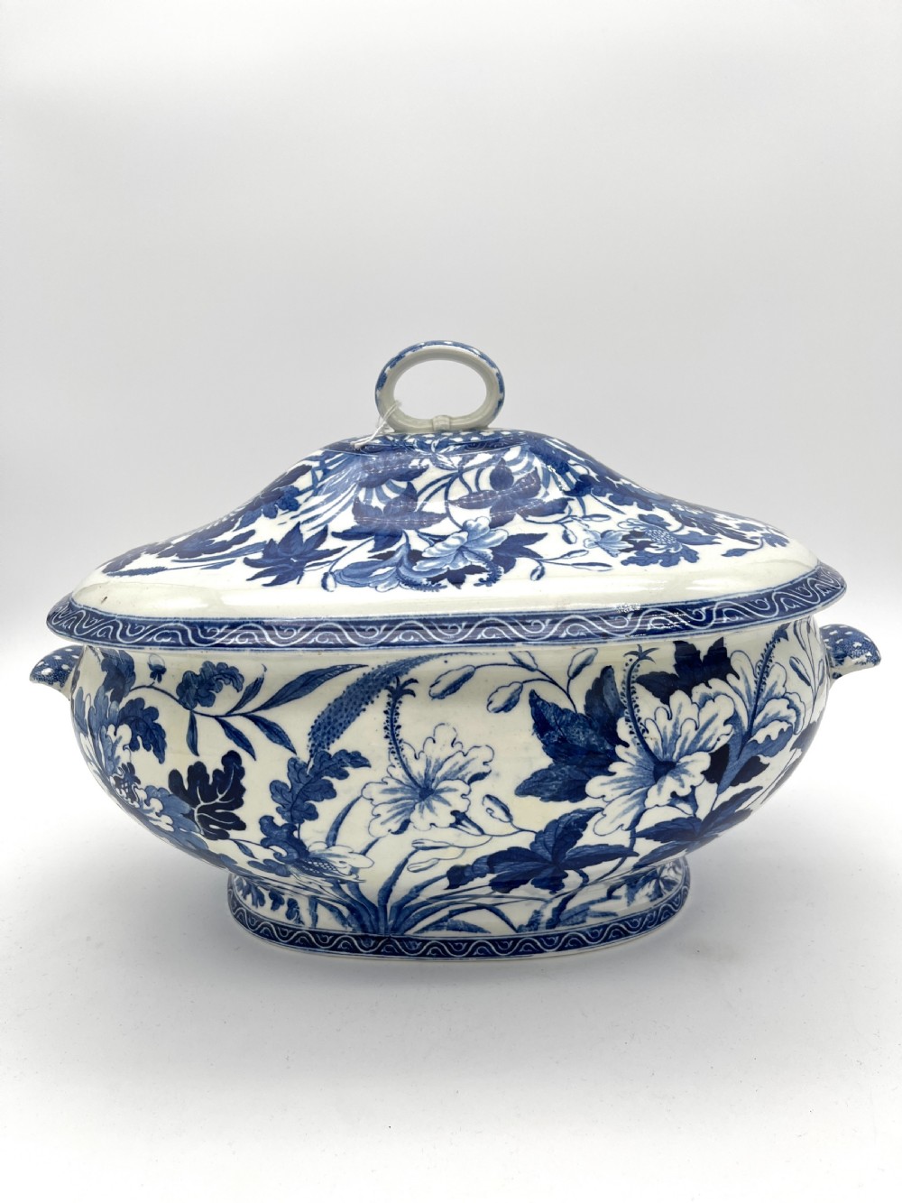An extensive blue and white transfer-printed Wedgwood earthenware dinner service in the Hibiscus pattern featuring plates, serving dishes, and a covered tureen. View XIX