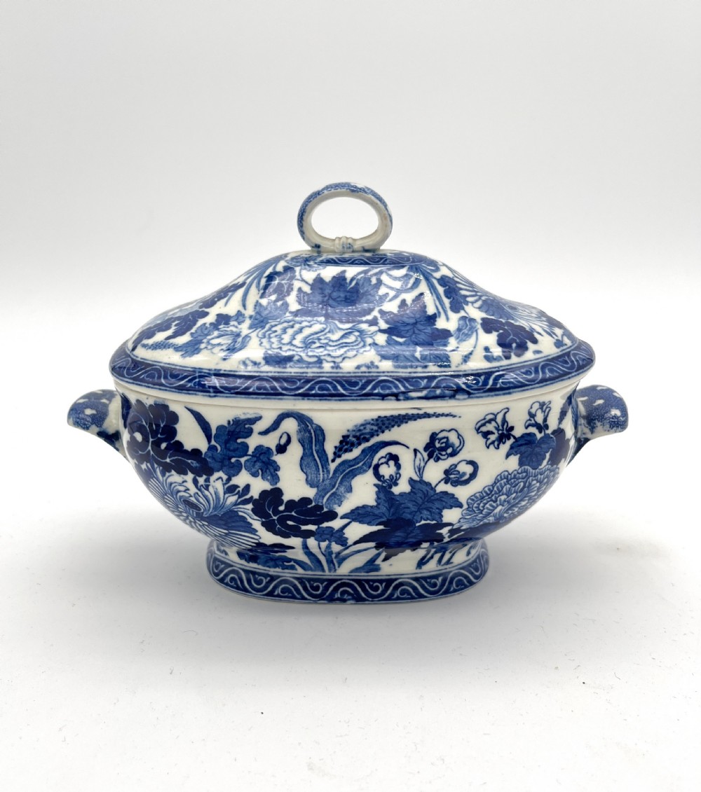 An extensive blue and white transfer-printed Wedgwood earthenware dinner service in the Hibiscus pattern featuring plates, serving dishes, and a covered tureen. View XXII