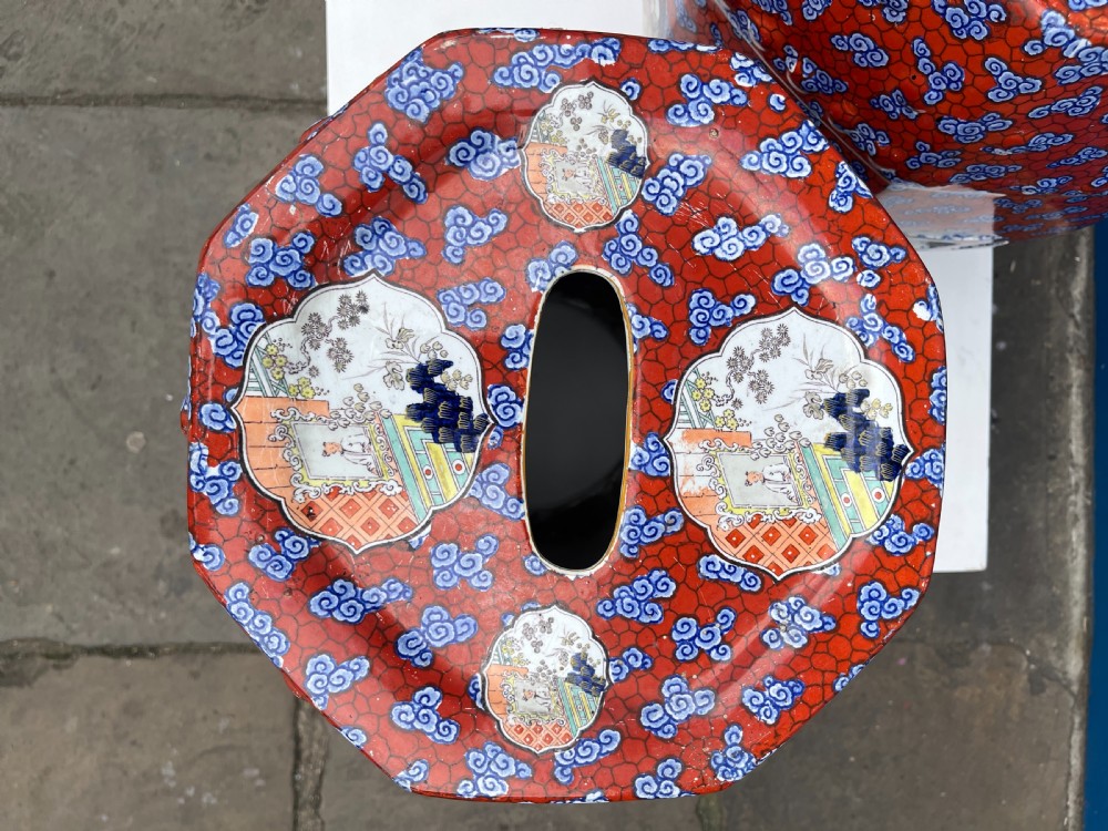 A pair of barrel-shaped clobbered ironstone garden seats decorated with red cloud patterns and reserve panels showing Chinese figures. View IV