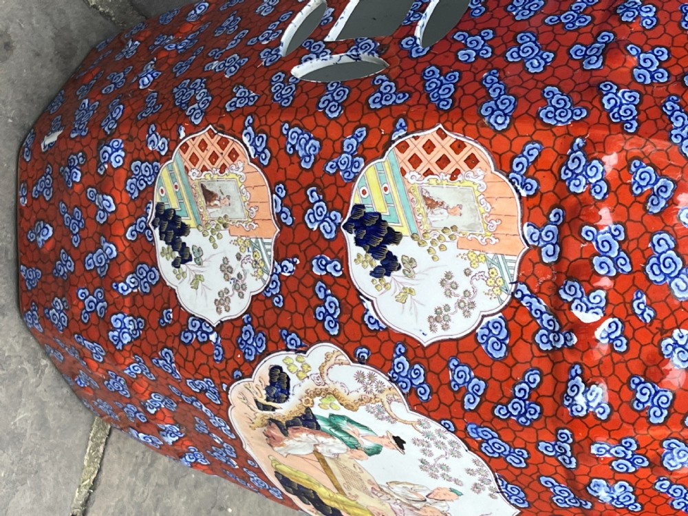 A pair of barrel-shaped clobbered ironstone garden seats decorated with red cloud patterns and reserve panels showing Chinese figures. View VII