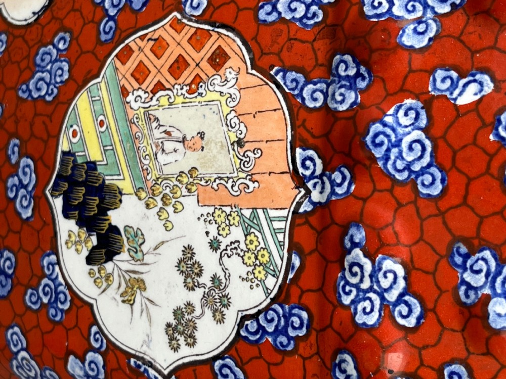 A pair of barrel-shaped clobbered ironstone garden seats decorated with red cloud patterns and reserve panels showing Chinese figures. View VIII