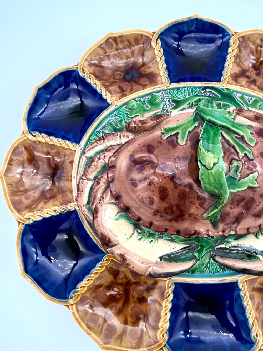 A Victorian Minton majolica ceramic tureen shaped as a crab with a green frog handle, resting on a blue and brown segmented platter. View III