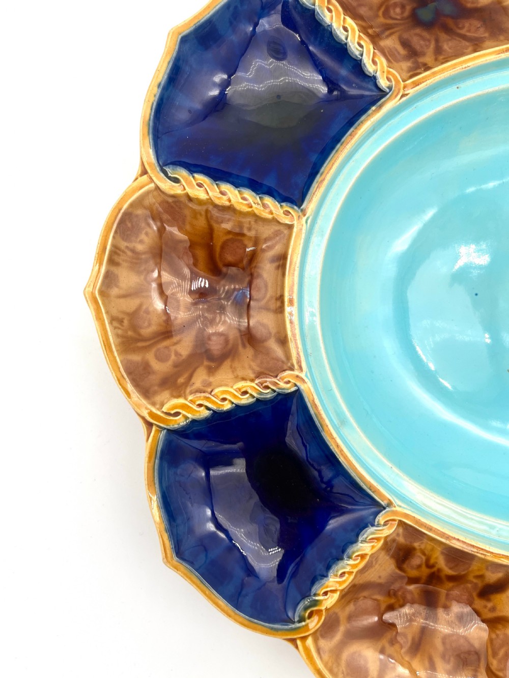 A Victorian Minton majolica ceramic tureen shaped as a crab with a green frog handle, resting on a blue and brown segmented platter. View V