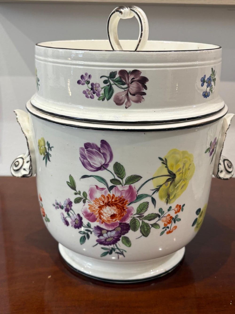 A pair of Georgian creamware ice pails decorated with hand-painted botanical flowers, featuring side scroll handles and tiered lids. View IV