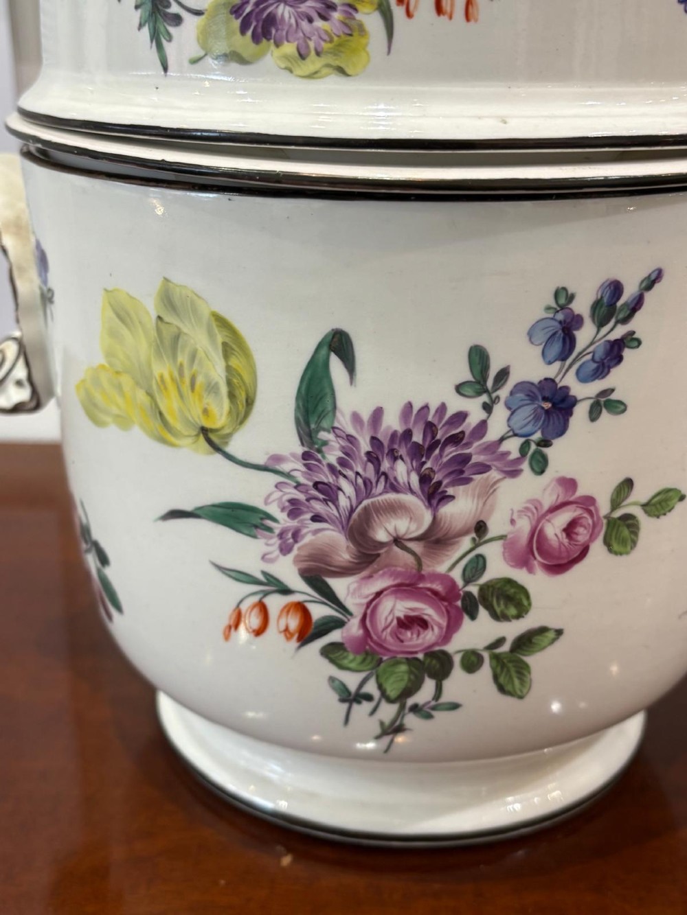 A pair of Georgian creamware ice pails decorated with hand-painted botanical flowers, featuring side scroll handles and tiered lids. View VI