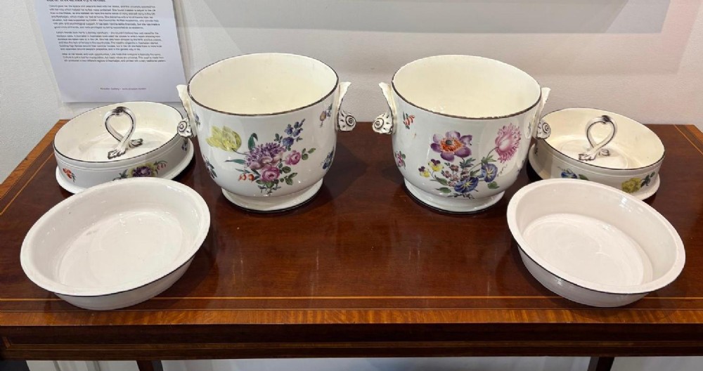 A pair of Georgian creamware ice pails decorated with hand-painted botanical flowers, featuring side scroll handles and tiered lids. View VIII