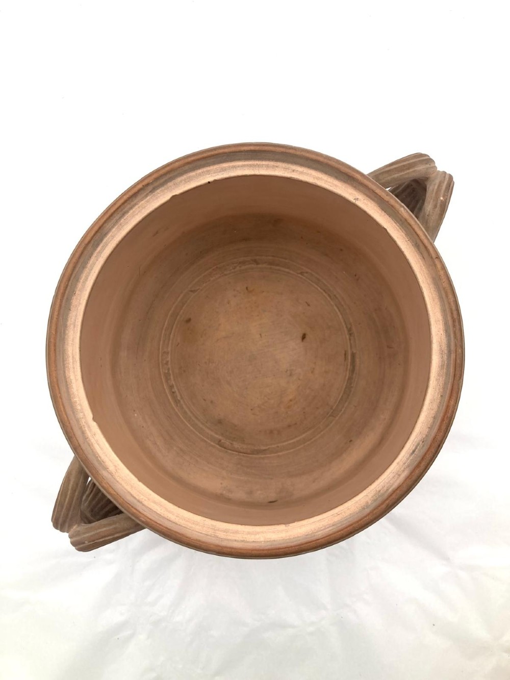 An unglazed terracotta wine cooler featuring twin scroll handles, a basketweave collar, and relief-moulded grape and vine leaf motifs. View VIII