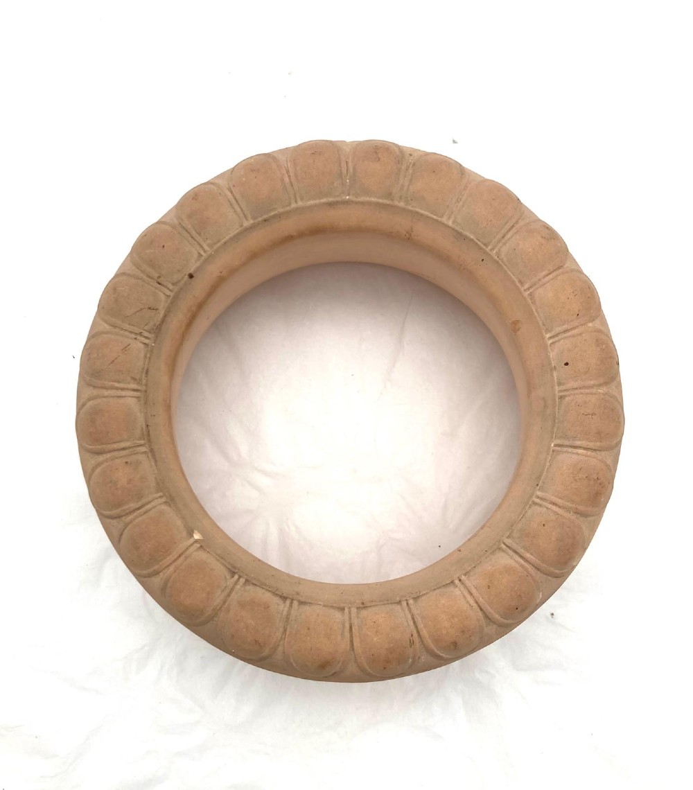An unglazed terracotta wine cooler featuring twin scroll handles, a basketweave collar, and relief-moulded grape and vine leaf motifs. View IX