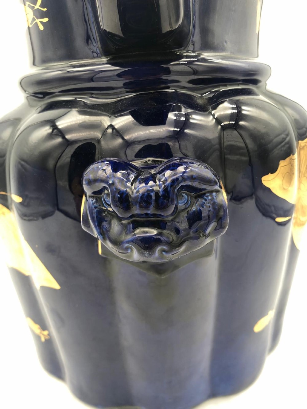 A deep cobalt blue porcelain jug decorated with gilded butterfly motifs and a wide spout, dating to circa 1820. View VI