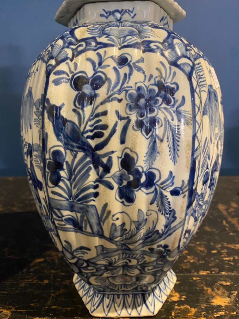 A pair of octagonal blue and white tin-glazed earthenware lidded vases decorated with hand-painted chinoiserie scenes and animal finials. View IV