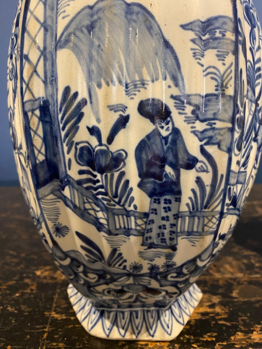 A pair of octagonal blue and white tin-glazed earthenware lidded vases decorated with hand-painted chinoiserie scenes and animal finials. View VII