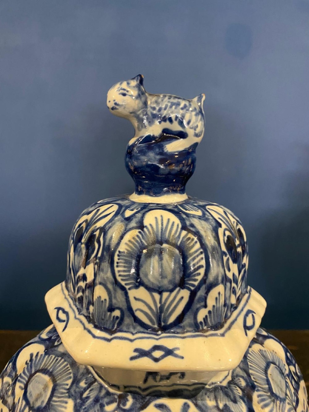 A pair of octagonal blue and white tin-glazed earthenware lidded vases decorated with hand-painted chinoiserie scenes and animal finials. View VIII