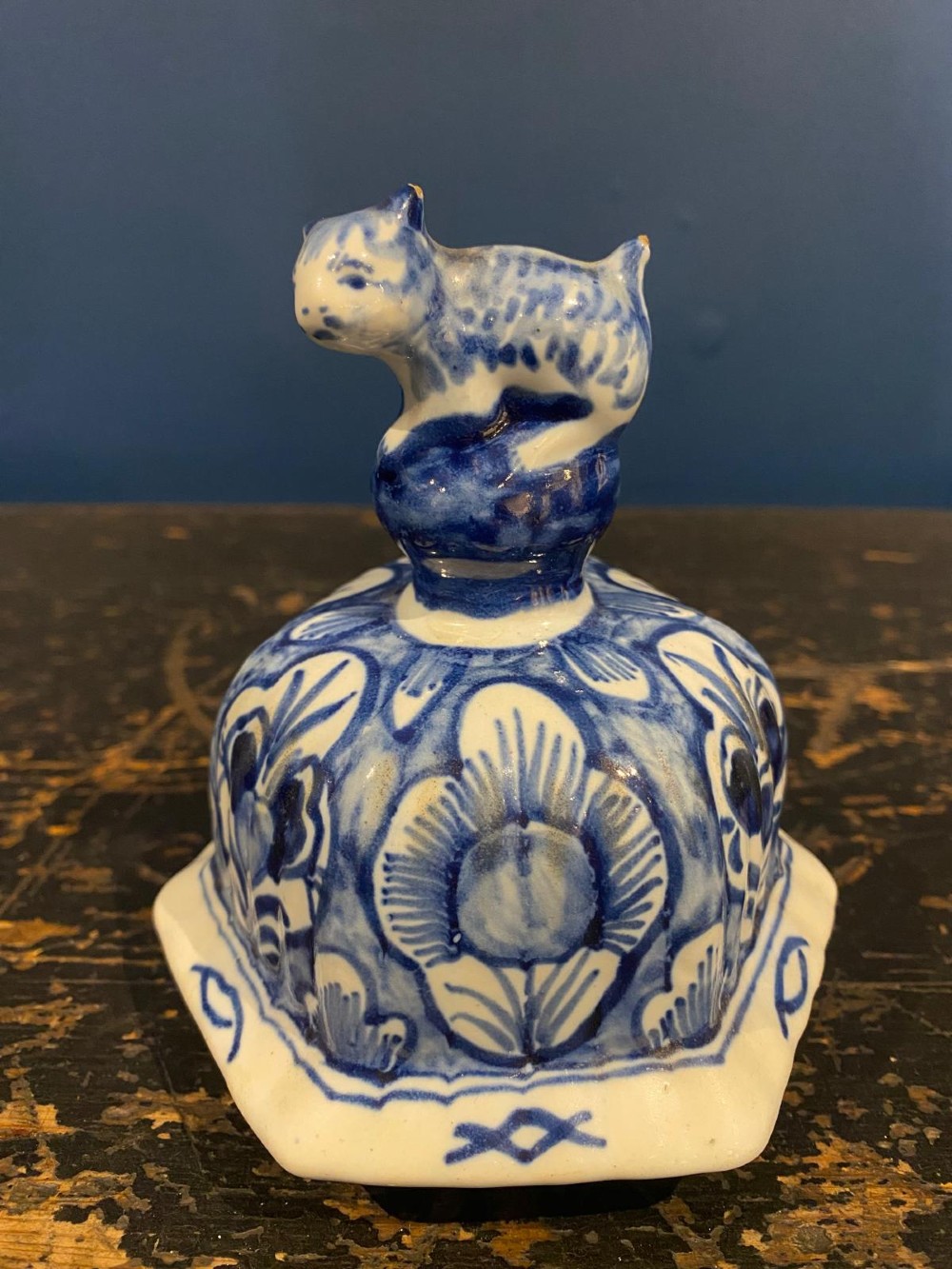 A pair of octagonal blue and white tin-glazed earthenware lidded vases decorated with hand-painted chinoiserie scenes and animal finials. View XII