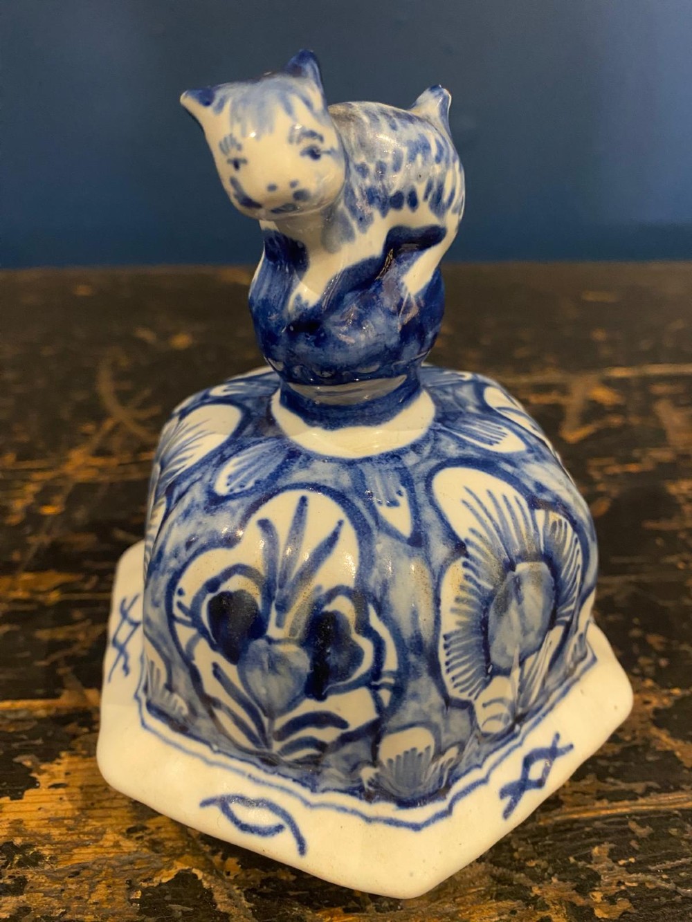 A pair of octagonal blue and white tin-glazed earthenware lidded vases decorated with hand-painted chinoiserie scenes and animal finials. View XIII
