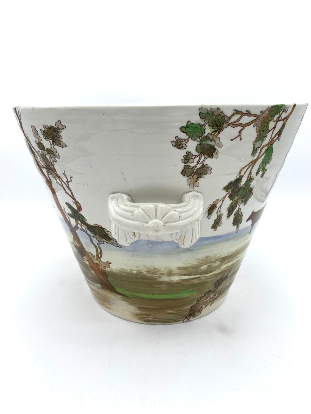 A cream earthenware Victorian milk pail decorated with brown painted cows under trees and lettering stating Pure Milk. View V