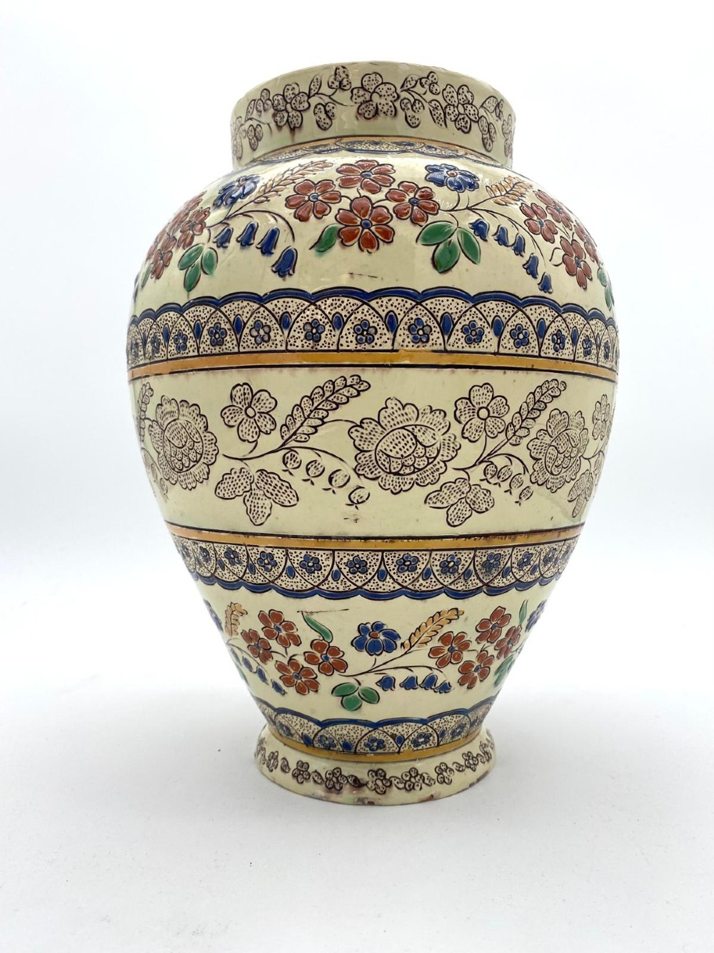 A late 19th-century bulbous Thoune earthenware vase decorated with hand-painted floral slipware motifs in terracotta, blue, and green over a cream background. View III