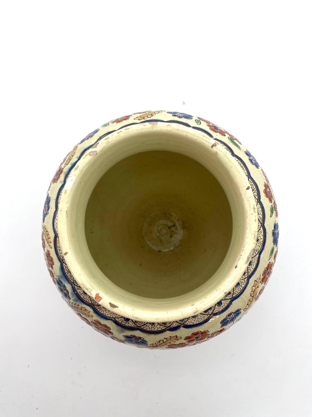 A late 19th-century bulbous Thoune earthenware vase decorated with hand-painted floral slipware motifs in terracotta, blue, and green over a cream background. View IV