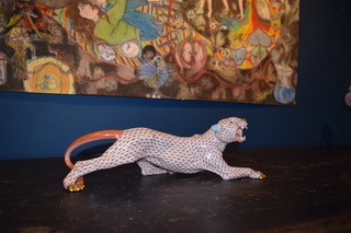 A hand-painted orange fishnet patterned porcelain jaguar sculpture in a prowling stance with gold paws and snout. View III