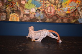 A hand-painted orange fishnet patterned porcelain jaguar sculpture in a prowling stance with gold paws and snout. View IV