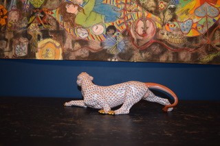 A hand-painted orange fishnet patterned porcelain jaguar sculpture in a prowling stance with gold paws and snout. View VII