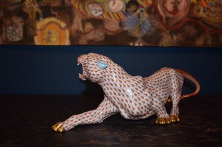 A hand-painted orange fishnet patterned porcelain jaguar sculpture in a prowling stance with gold paws and snout. View VIII