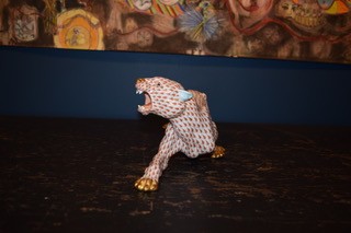 A hand-painted orange fishnet patterned porcelain jaguar sculpture in a prowling stance with gold paws and snout. View X
