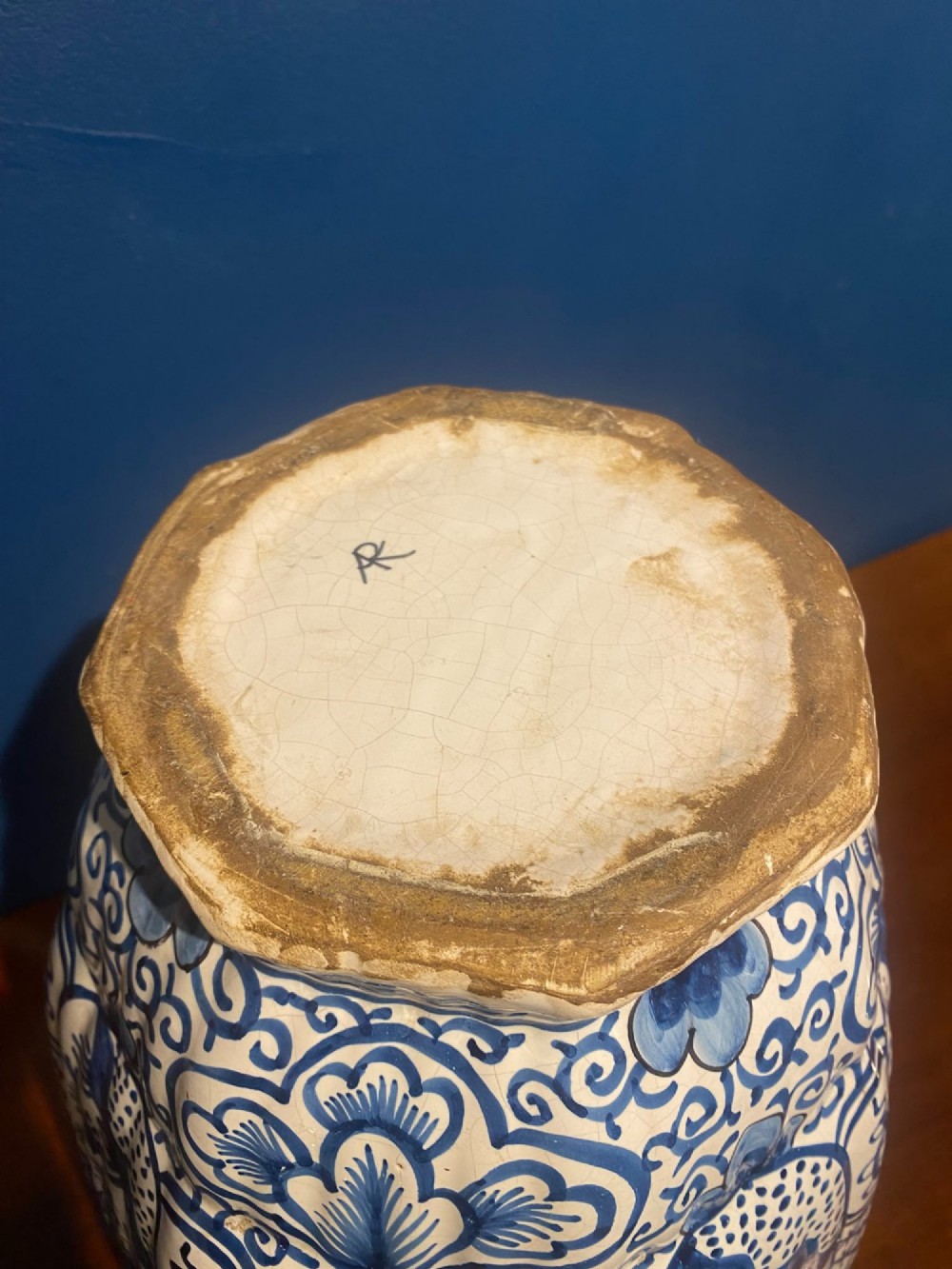 A pair of mid-19th century ribbed blue and white tin-glazed earthenware lidded vases hand-painted with oriental landscapes and topped with seated lion finials. View XIV