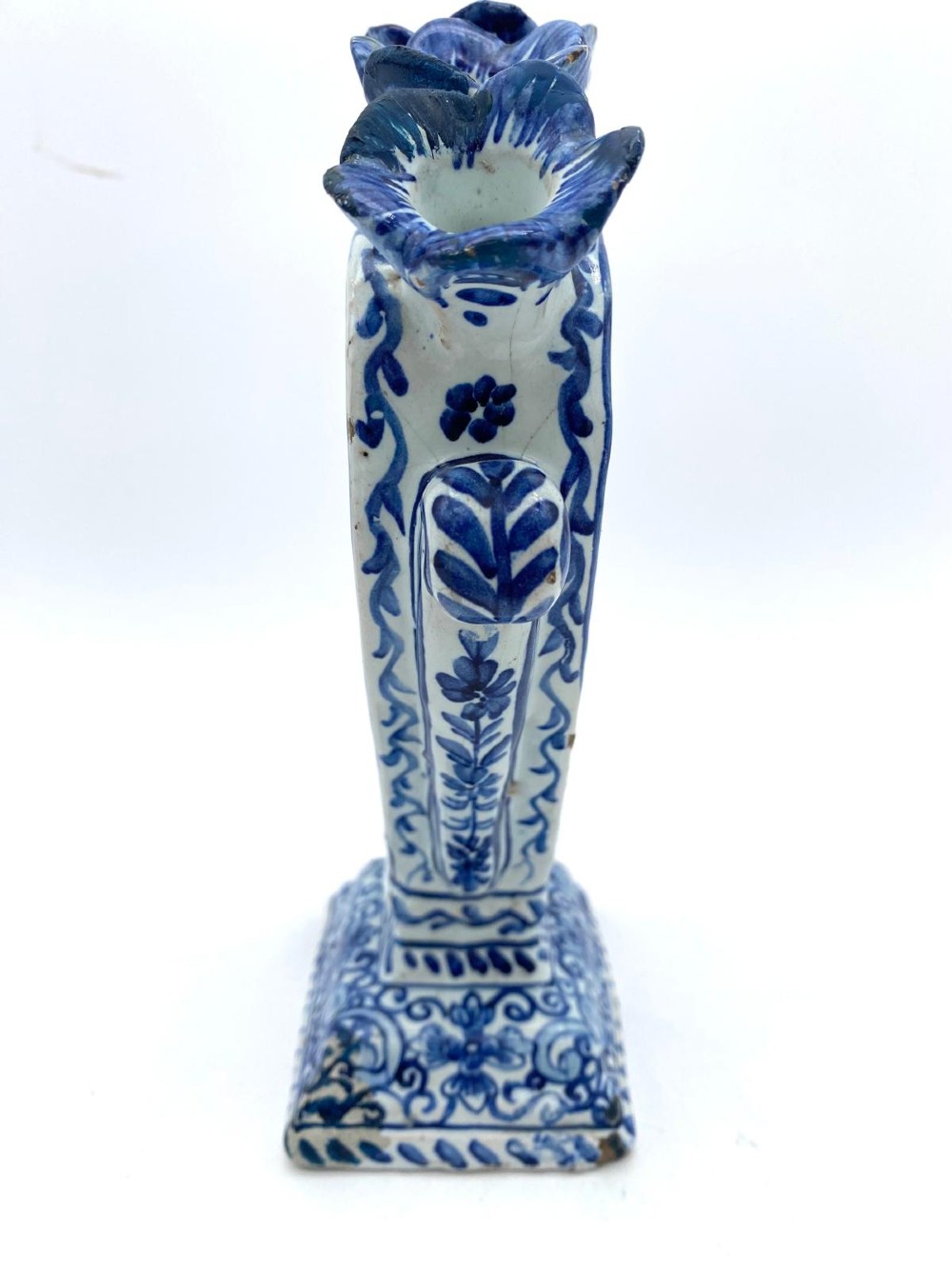 A pair of blue and white heart-shaped ceramic tulipieres featuring multiple spouts and hand-painted Dutch figures in landscape settings. View VII