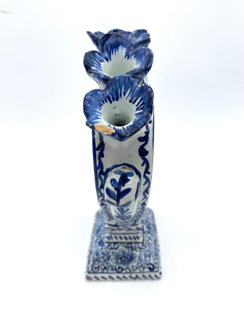 A pair of blue and white heart-shaped ceramic tulipieres featuring multiple spouts and hand-painted Dutch figures in landscape settings. View XII