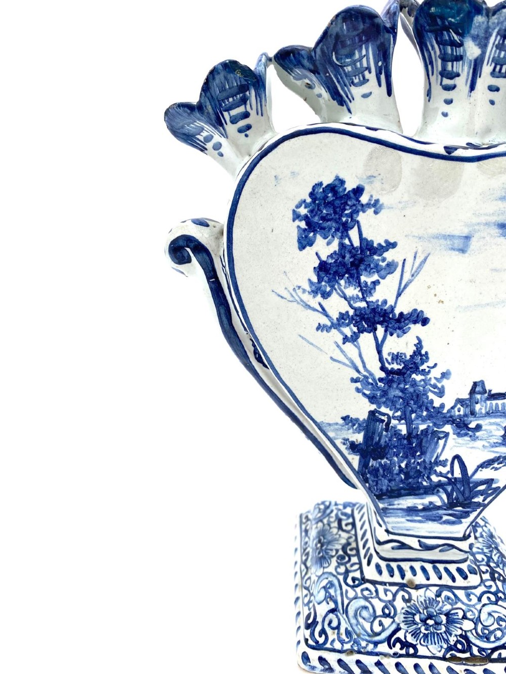 A pair of blue and white heart-shaped ceramic tulipieres featuring multiple spouts and hand-painted Dutch figures in landscape settings. View XIV